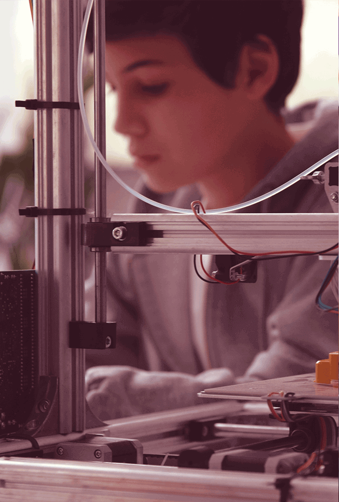 Student working with a 3D printer